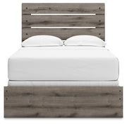 Graystorm bedroom set by Ashley Furniture featuring a modern bed with matching nightstands and a cozy, stylish bedroom design.