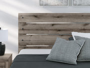 Gray Ashley Furniture Bedroom Set with bed frame, nightstands, and dresser in a cozy modern bedroom.