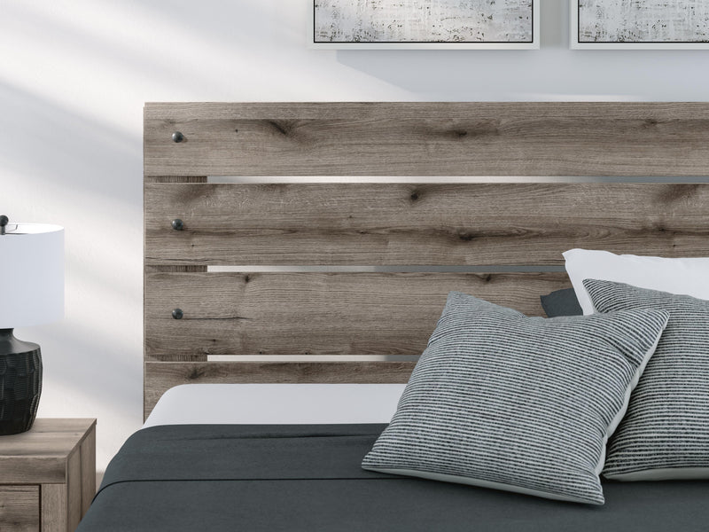 Gray Ashley Furniture Bedroom Set with bed frame, nightstands, and dresser in a cozy modern bedroom.