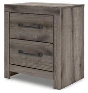 Graystorm bedroom set by Ashley Furniture, showing the bed, nightstands, and dresser in a modern gray finish from an angled view.