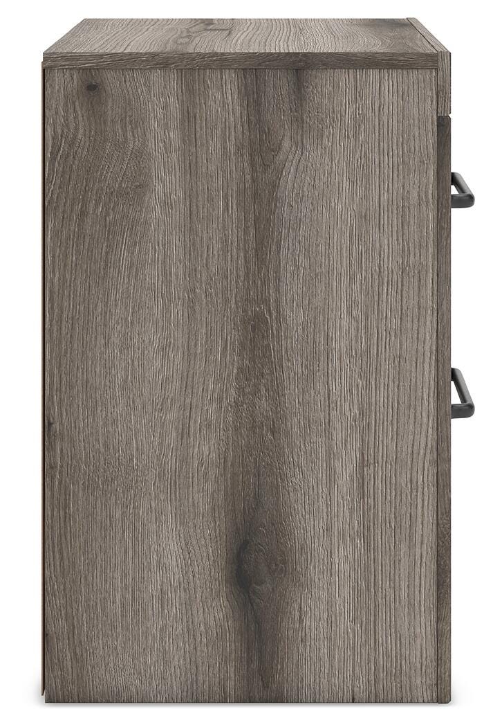 Graystorm bedroom set by Ashley Furniture includes a bed, nightstands, and dresser in a modern gray finish.