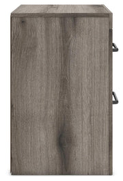 Graystorm bedroom set by Ashley Furniture featuring a modern bed frame, nightstands, and matching bedroom furniture in gray finish.