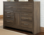 Ashley Furniture Juararo dresser with dark wood finish and silver hardware, featuring multiple drawers and a modern design.