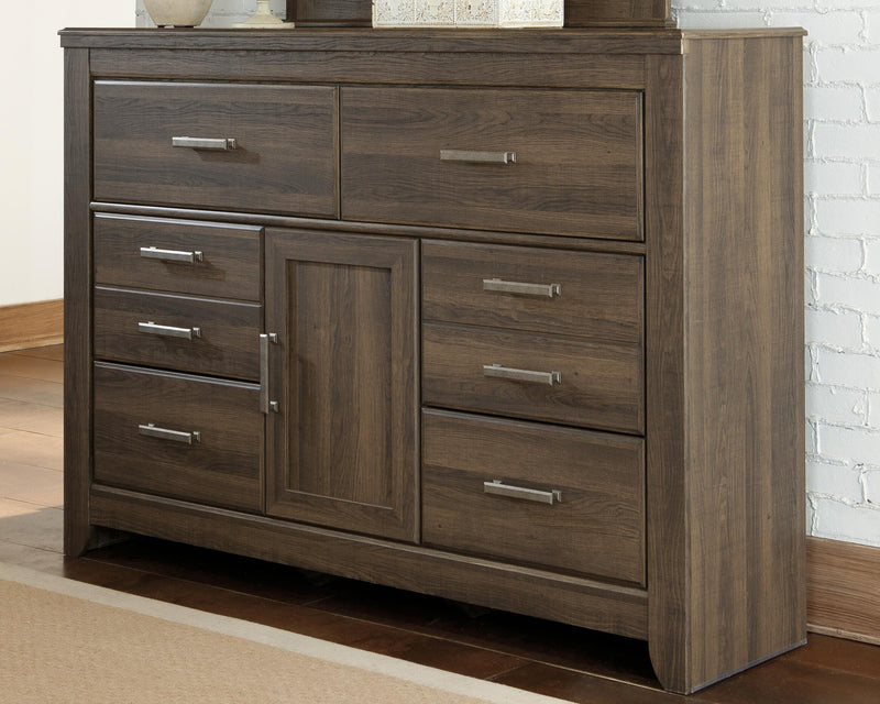 Ashley Furniture Juararo dresser with dark wood finish and silver hardware, featuring multiple drawers and a modern design.