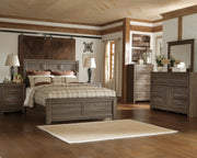 Ashley Furniture Juararo bedroom set with a modern bed frame, matching nightstands, and coordinating dresser in a stylish bedroom.