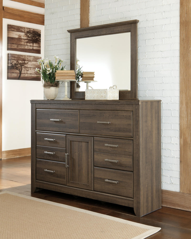 Ashley Furniture Juararo bedroom set with a dark wood finish, includes a bed frame, dresser, and nightstands, shown in a modern bedroom setting.