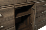 Ashley Furniture Juararo dresser with matching mirror, showcasing a modern wood finish and sleek storage drawers.