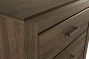 Detailed view of Ashley Furniture Juararo chest of drawers showcasing its elegant wood finish and classic design.