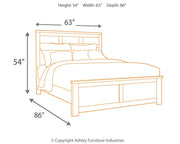 Ashley Furniture Juararo bedroom set featuring a bed, matching nightstands, and dresser with elegant wood finish and classic design.
