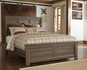 Ashley Furniture Juararo bedroom set with a modern bed frame, matching nightstands, and dresser in a stylish bedroom scene.