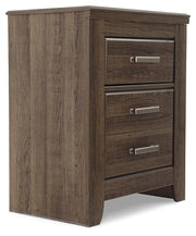 Ashley Furniture Juararo nightstand with a dark wood finish and modern design, shown from an angled view.