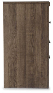 Ashley Furniture Juararo nightstand with a dark wood finish and sleek drawer handle, shown from a side angle.