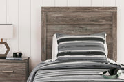 Close-up of the Ashley Furniture Ralinksi Bedroom Set showing detailed wood finish and elegant bed frame design.