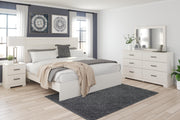 Ashley Furniture Stelsie bedroom set featuring a bed frame, matching nightstands, and dresser in a modern bedroom design.
