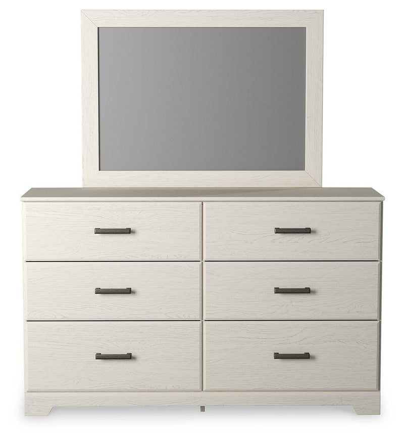 Ashley Furniture Stelsie bedroom set with a headboard, dresser, and nightstands in a modern, stylish bedroom arrangement.