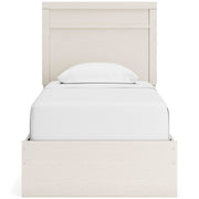Ashley Furniture Stelsie bedroom set featuring a bed with a padded headboard and matching nightstands in a modern bedroom scene.