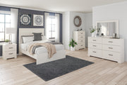 Ashley Furniture Stelsie Bed with upholstered headboard and sleek wooden frame, shown in a modern bedroom setting.