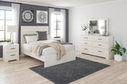 Ashley Furniture Stelsie Bedroom Set featuring a bed, nightstands, and dresser in a modern bedroom design.