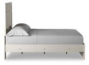 Ashley Furniture Stelsie Bed with upholstered headboard and wooden frame, shown from the side in a modern bedroom setting.