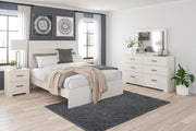 Ashley Furniture Stelsie bedroom set featuring a bed with a tufted headboard, matching nightstands, and elegant bedroom decor.