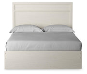 Ashley Furniture Stelsie Bed with a sleek headboard in a modern bedroom setting.
