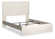 Ashley Furniture Stelsie Bed with wooden frame, angled view showcasing the modern design and rich finish.