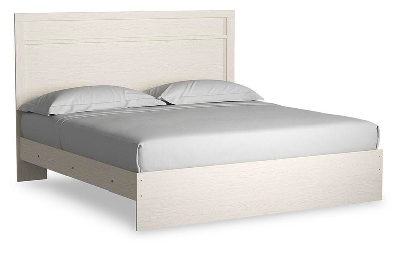 Ashley Furniture Stelsie bedroom set with a bed, nightstands, and dresser in a cozy, modern bedroom scene.