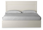 Ashley Furniture Stelsie bed with a headboard featuring a sleek, modern design and neutral upholstery for a stylish bedroom look.