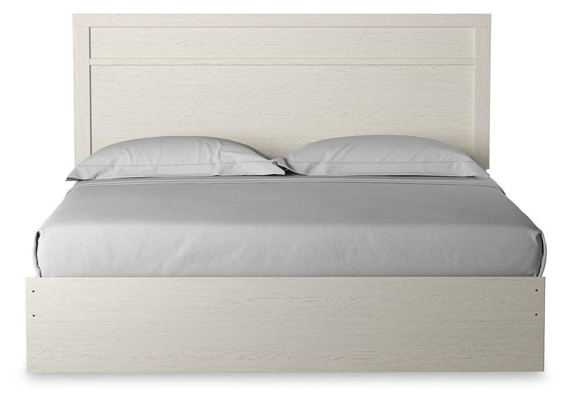 Ashley Furniture Stelsie bed with a headboard featuring a sleek, modern design and neutral upholstery for a stylish bedroom look.