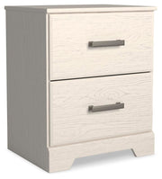 Ashley Furniture Stelsie bedroom set shown from an angled view, including bed frame, nightstands, and matching bedroom furniture.