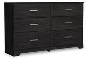Ashley Furniture Belachime dresser with closed drawers, wood finish, and angled design viewed from a side angle.