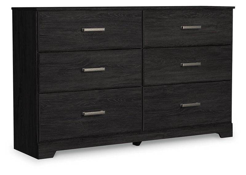 Ashley Furniture Belachime dresser with closed drawers, wood finish, and angled design viewed from a side angle.