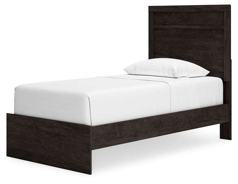 Ashley Furniture Belachime bed with a wooden frame, detailed headboard, and neutral finish, shown from an angled side view.
