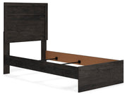 Ashley Furniture Belachime bedroom set shown from a side angle, including a bed frame, nightstands, and matching bedroom furniture.