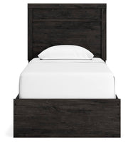 Ashley Furniture Belachime Bed with a stylish headboard and rich wood finish, showcasing a modern bedroom design.