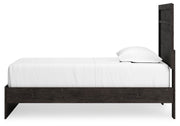 Ashley Furniture Belachime bedroom set featuring a bed with a headboard and matching side tables in a modern design.