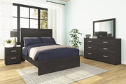 Ashley Furniture Belachime bedroom set featuring a wooden bed frame, matching nightstands, and coordinated bedroom furniture.
