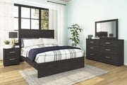 Ashley Furniture Belachime Bed with a wooden frame and elegant headboard design, shown in a cozy bedroom setting.