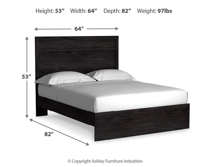 Ashley Furniture Belachime bed with a wooden frame and detailed headboard, shown in a cozy bedroom setting.