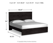 Ashley Furniture Belachime bed with a classic wooden frame and detailed headboard in a warm finish.