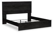 Ashley Furniture Belachime bed shown from an angled side view, featuring a stylish and sturdy bed frame in a modern design.