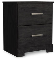 Ashley Furniture Belachime nightstand with a closed drawer and wood finish, shown from an angled side view in a bedroom setting.