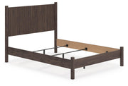 Ashley Furniture Pamytta Bed with beige upholstered headboard and wooden frame, shown from an angled side view.