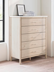 Ashley Furniture Cadmori chest of drawers with a modern wood finish, featuring multiple drawers and sleek design.