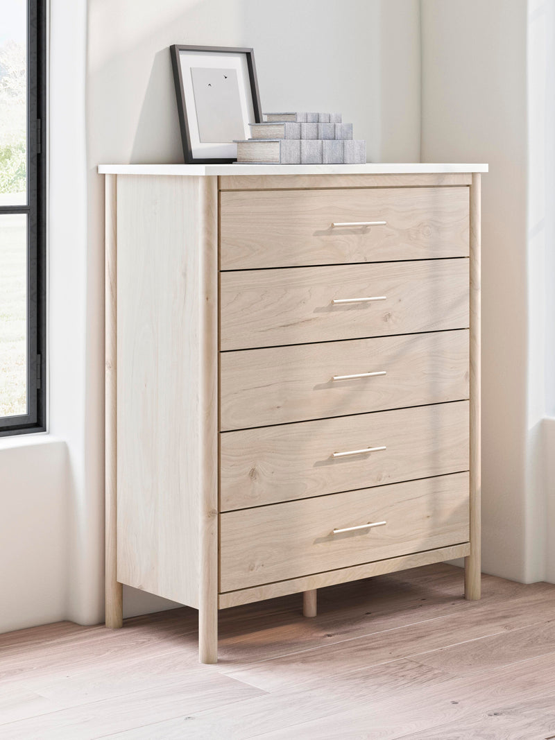 Ashley Furniture Cadmori chest of drawers with a modern wood finish, featuring multiple drawers and sleek design.
