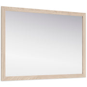 Ashley Furniture Cadmori bedroom mirror displaying a sleek, rectangular mirror with a wooden frame, angled to show its reflective surface.