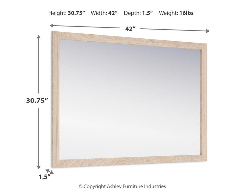 Ashley Furniture Cadmori bedroom mirror with a sleek, modern design and wooden frame, shown hanging on a bedroom wall.
