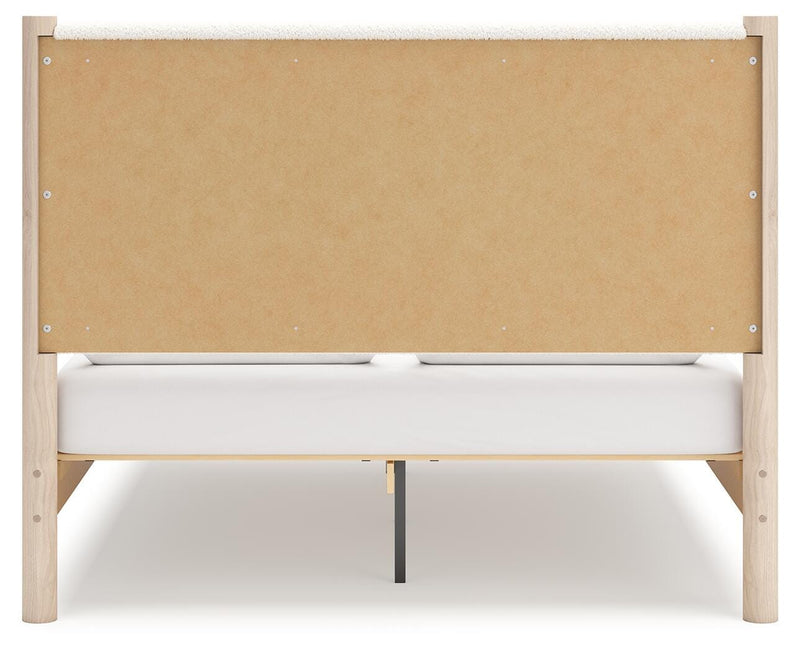 Ashley Furniture Cadmori upholstered bed with plush fabric headboard and frame, shown from the back view.
