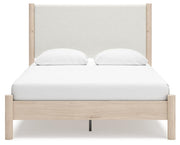 Ashley Furniture Cadmori upholstered bed with padded headboard and neutral fabric, shown from a front head-on view.