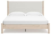 Ashley Furniture Cadmori upholstered bed with a plush headboard and neutral fabric, shown from a front head-on view.